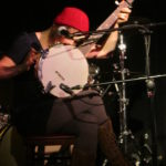 Rachael Marie singing into banjo.