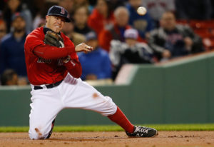 Brock Holt makes a play from his knees. (Photo Credit: Jim Rogash/Getty Images North America)