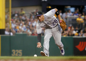 Nolan Arenado goes to barehand a slow roller. (Photo by Justin K. Aller/Getty Images)