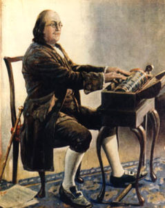 Ben Franklin playing his invention (Photo via: glassarmonica.com)