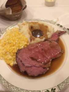 Prime rib with sweet corn and mashed potatoes and gravy