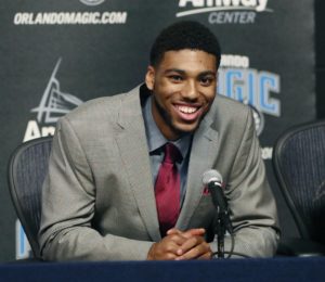 Devyn Marble smiling at podium of his introductory press conference in Orlando