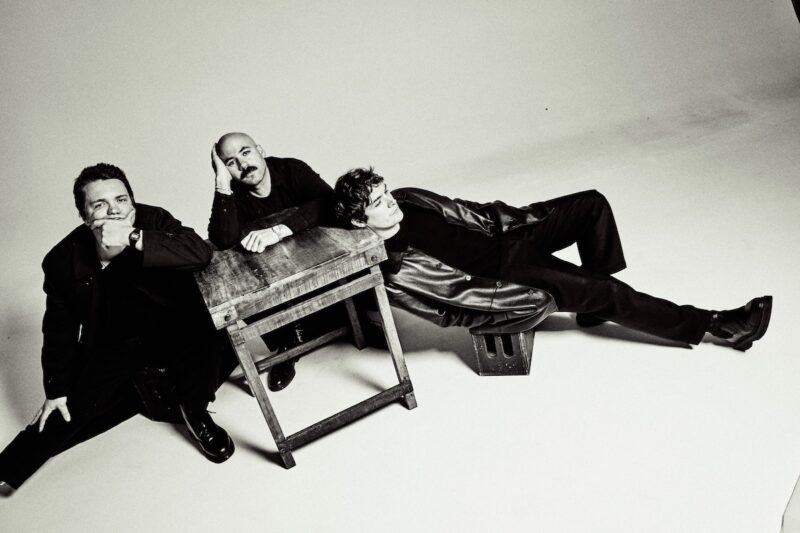 A group of three people sitting together