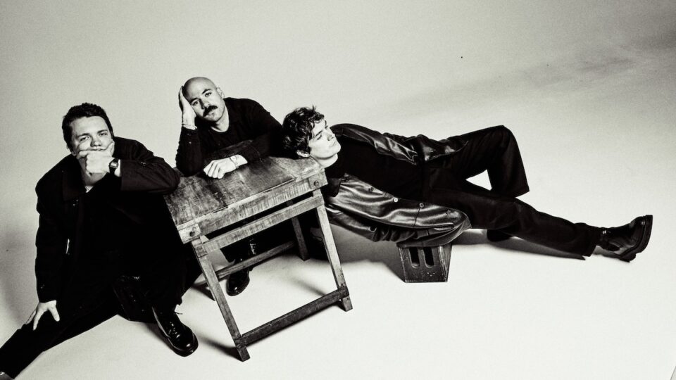 A group of three people sitting together